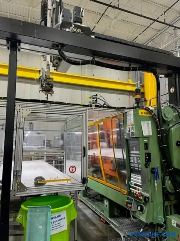 Automated injection molding machine in factory setting