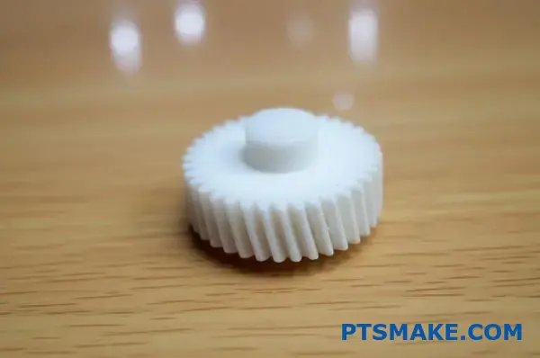 Precision plastic drive gear showing detailed tooth structure and smooth surface finish on workspace