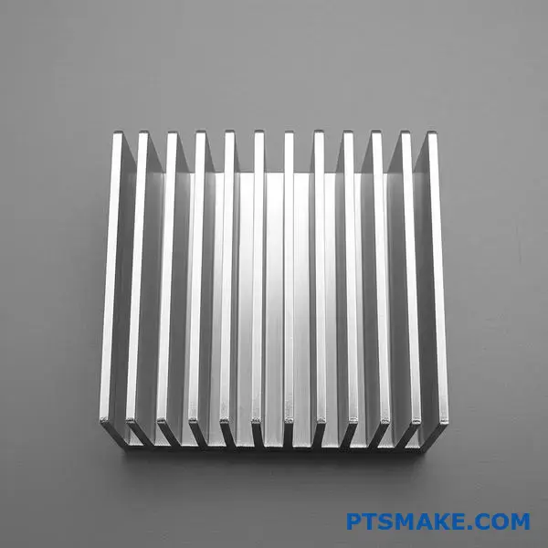 Professional view of anodized aluminum heat sink showing surface finish quality and metallic texture on desk surface