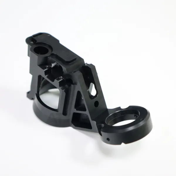 Black plastic component with bores and mounting features